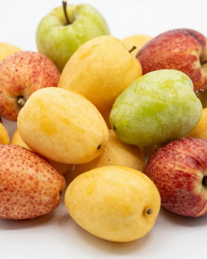 Primer plano macro de masmelos de fruta de colores vivos sobre fondo claro, luz natural difusa, textura suave visible, c